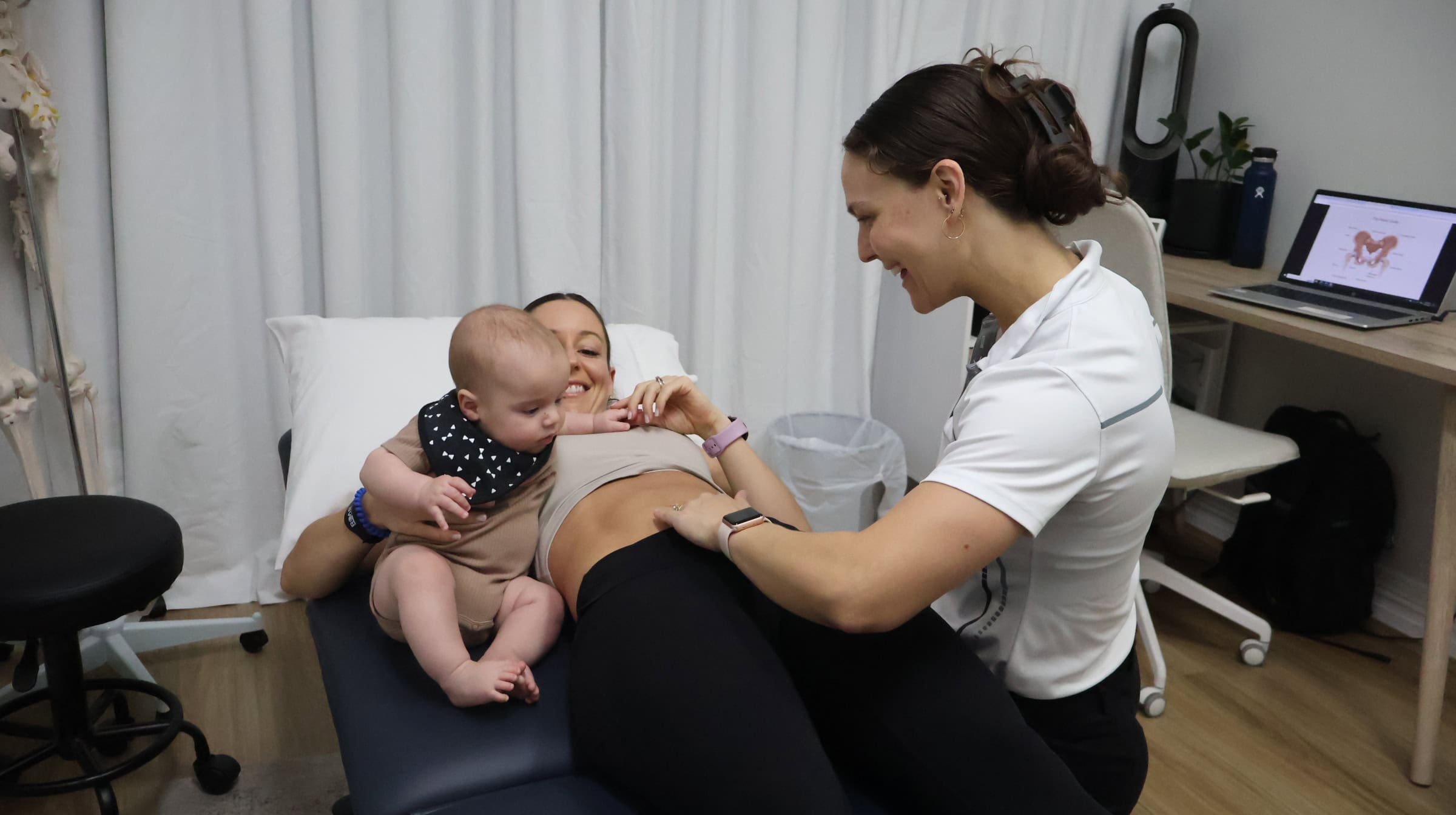 Physiotherapist consulting with woman and child