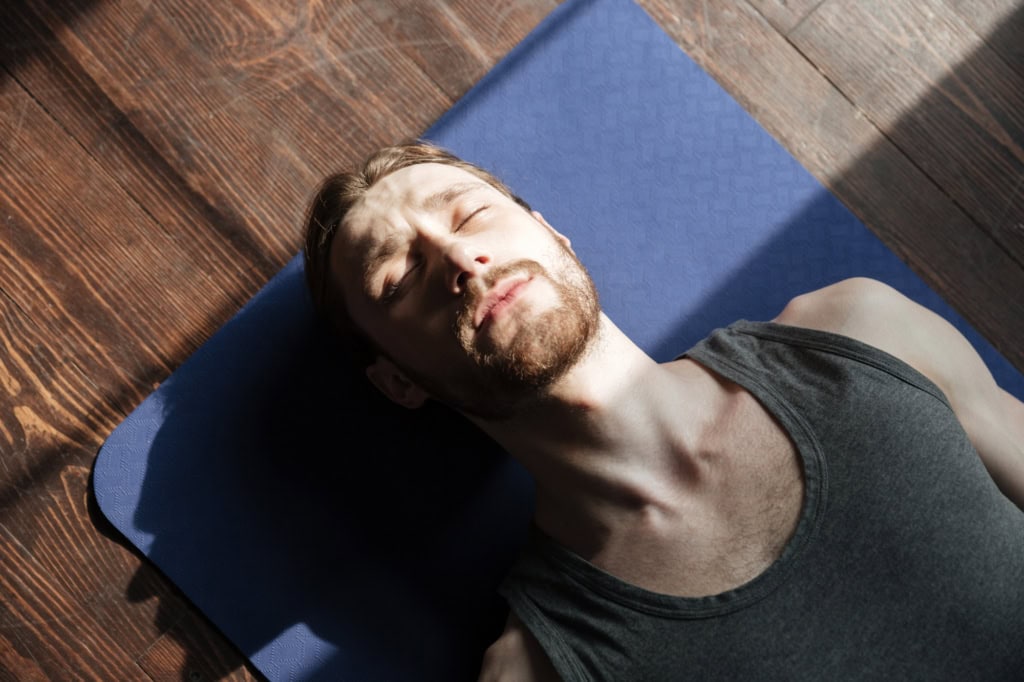 Man laying on yoga mat
