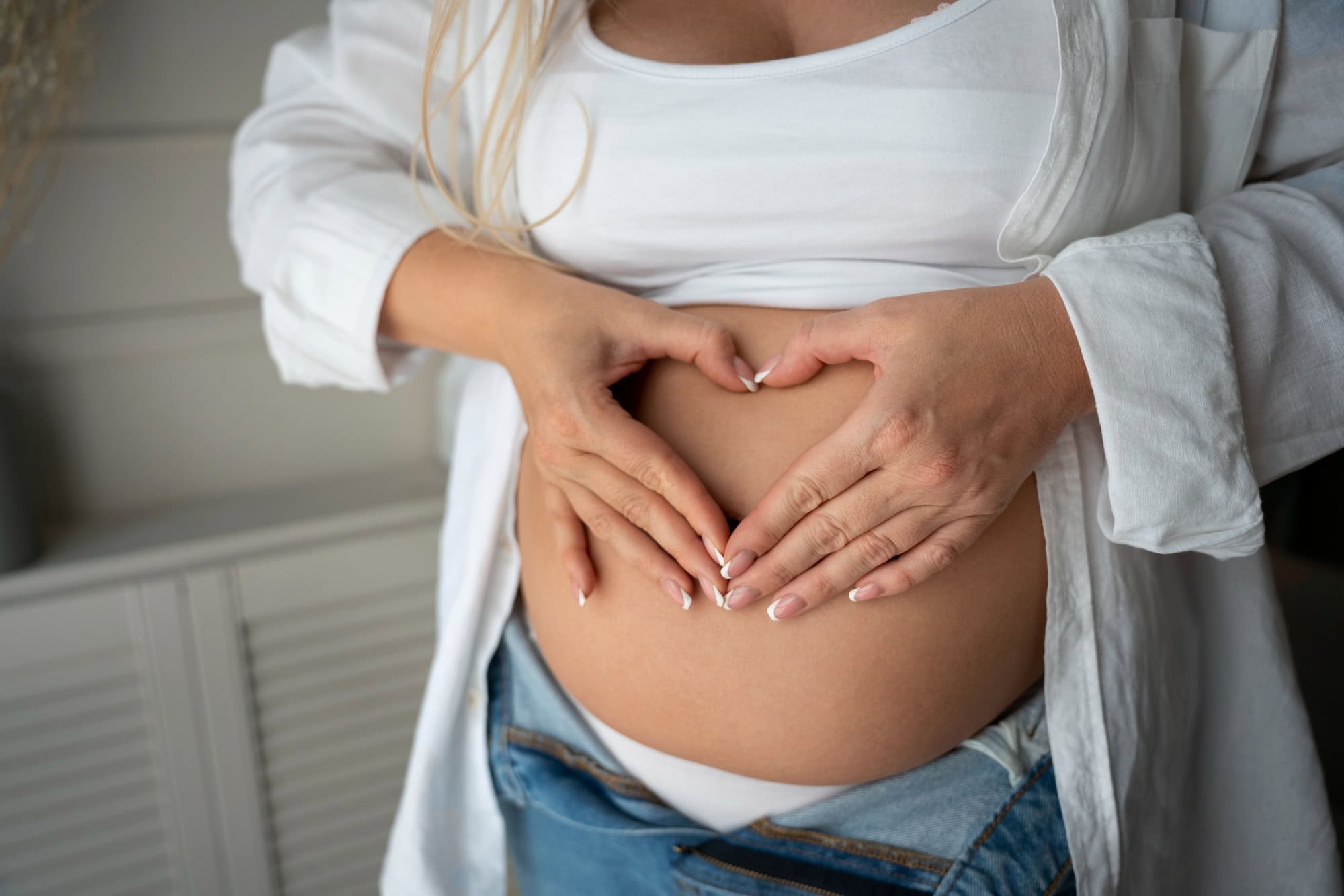 Pregnant woman holding tummy