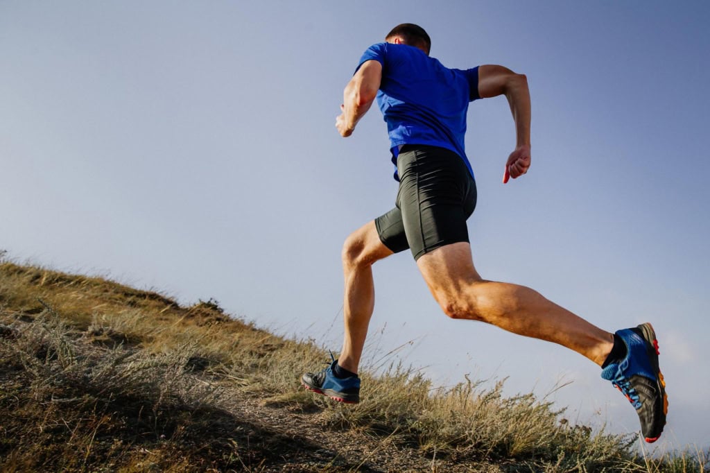 Athlete running up a hill