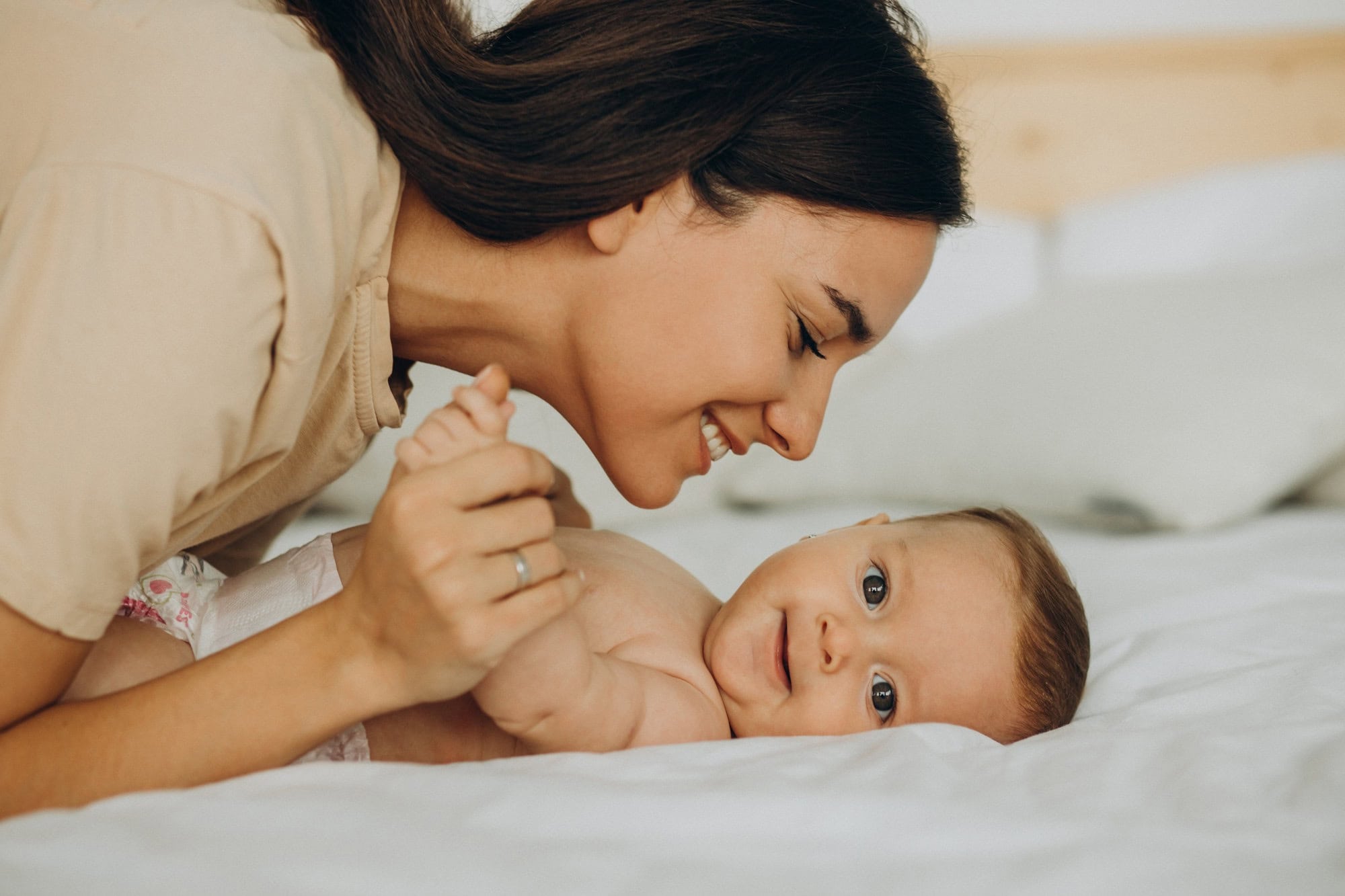 Women smiling looking over baby