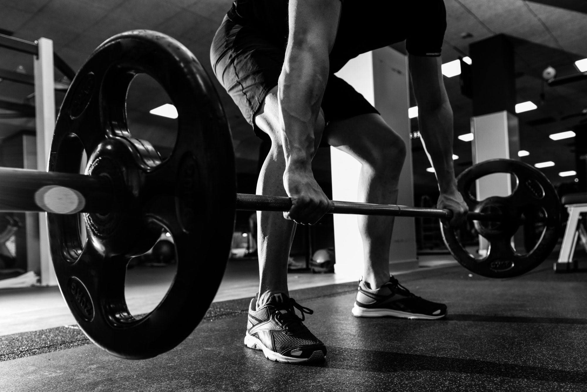 Greyscale image of a deadlift in a physiotherapy session